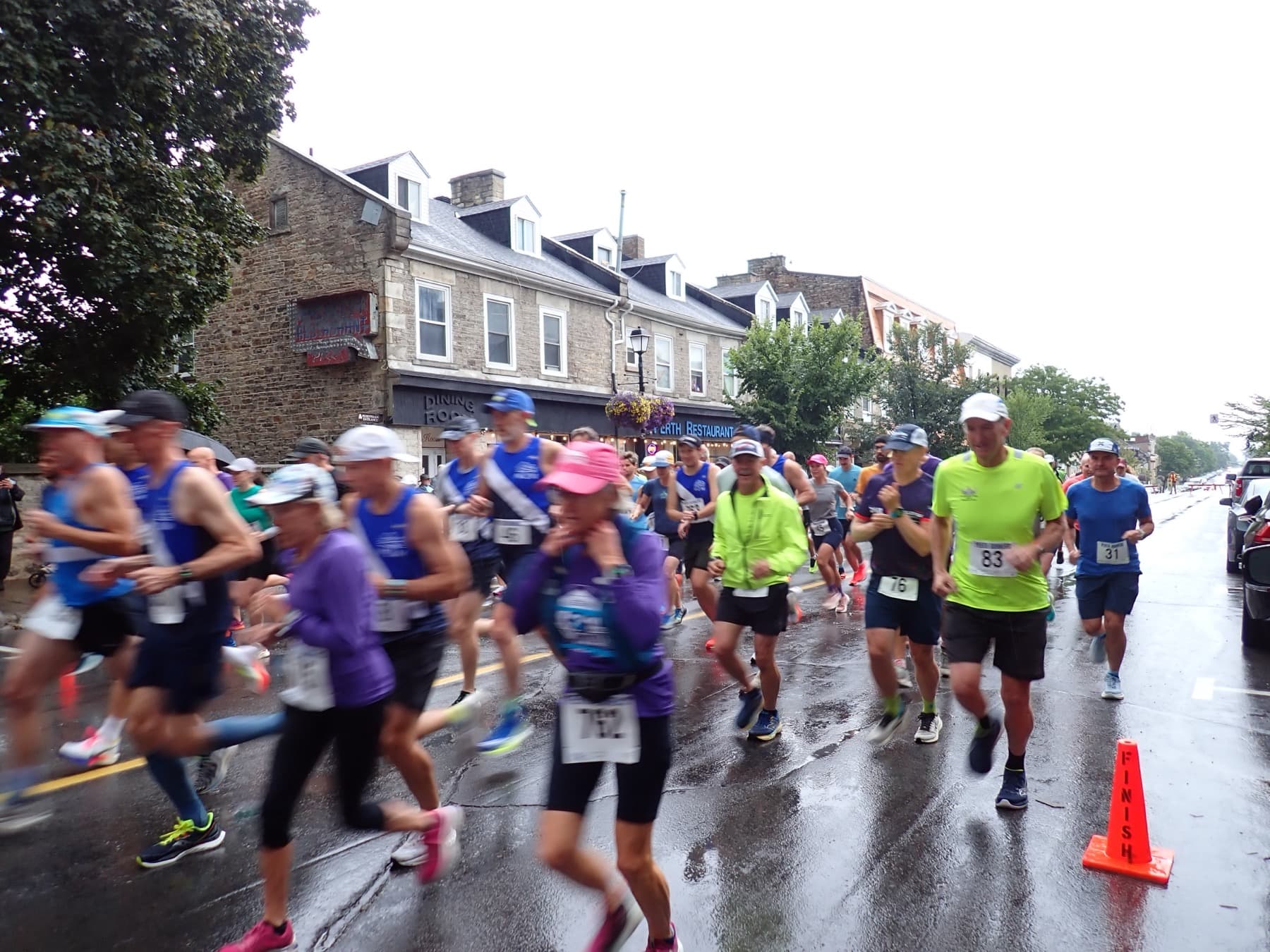 Runners on a rainy street during the Glen Tay Road Race.
